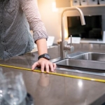 man measuring kitchen countertop