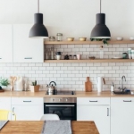 white kitchen with white subway tiles open shelving