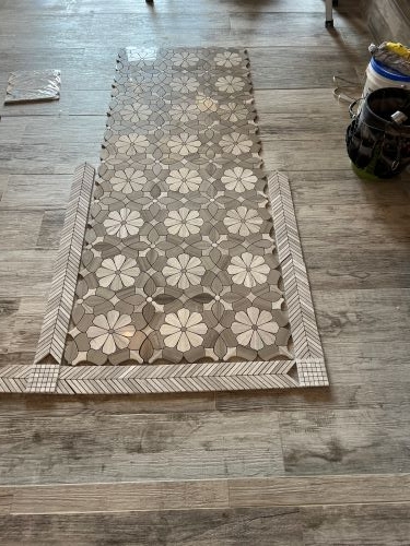 Mosaic tile floor for shower in progress